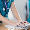 Female Nurse Typing on Laptop at Desk iStock 687660868 thumb